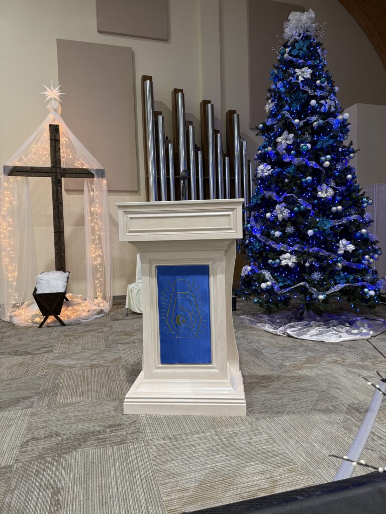 Church pulpit with Christmas tree and cross.