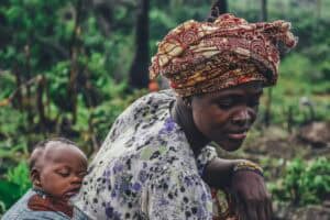 Woman carrying baby on her back outdoors